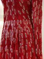 Elegant red dress featuring intricate sequin embroidery and detailed beadwork, perfect for special occasions, parties, or evening events. Made with high-quality materials for a glamorous look.