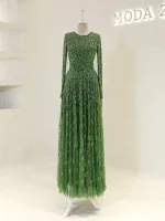 Luxurious green night dress with intricate beadwork, long sleeves, and flowing tulle skirt, perfect for special occasions or celebrations.