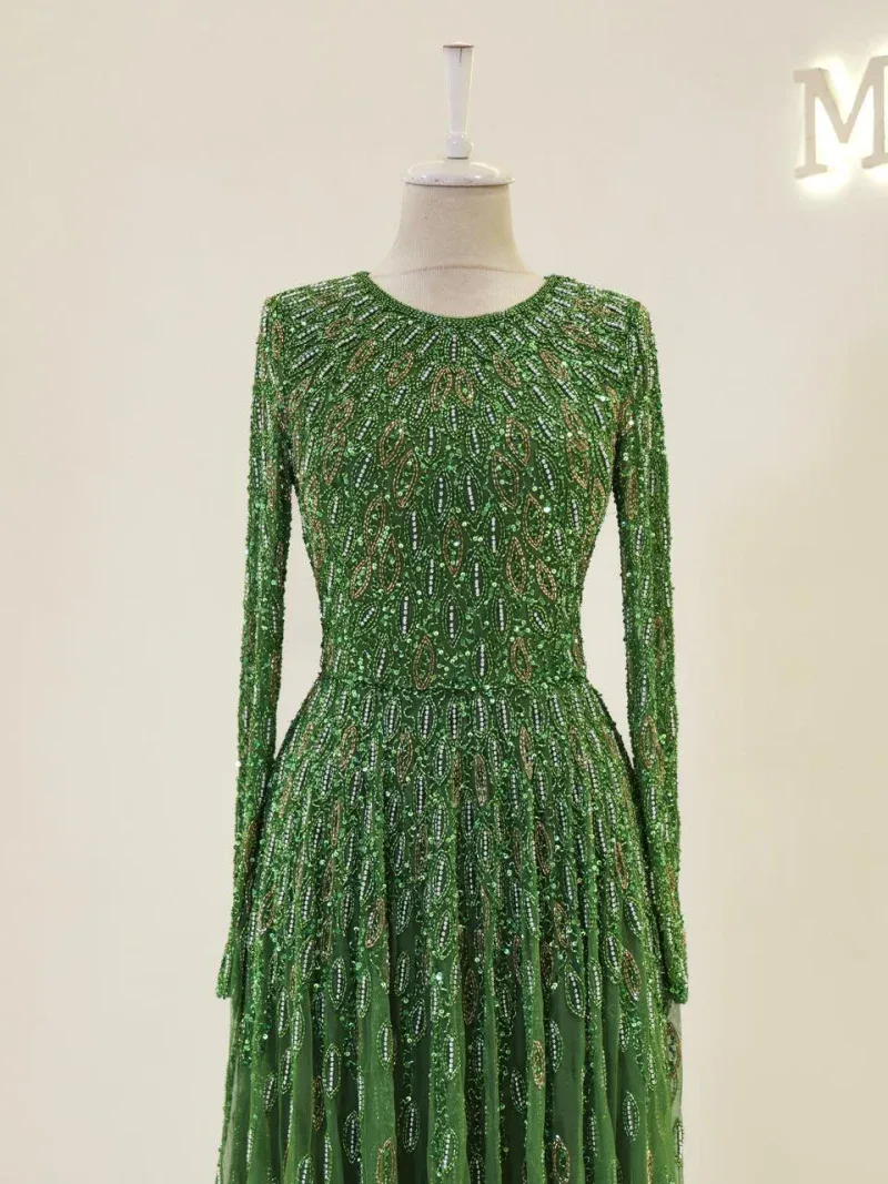 Exquisite green dress adorned with intricate embroidery and sequins, perfect for special occasions or celebrations.