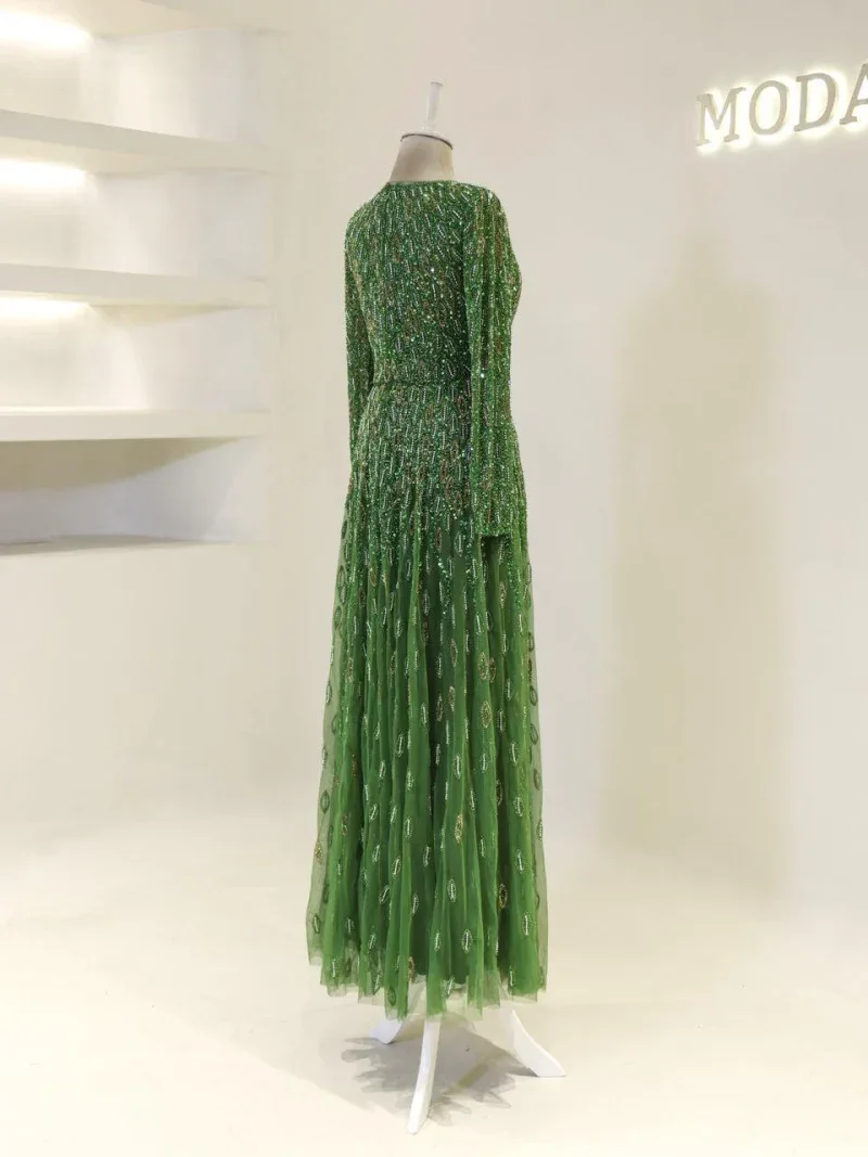 Green long evening gown with intricate beadwork and embroidery, perfect for special occasions and parties. Luxurious, stylish, and eye-catching fashion piece.