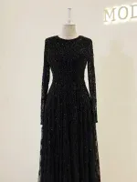 Luxurious black evening dress with intricate beadwork and shimmering details, perfect for formal occasions and special events. Made with high-quality materials for a stunning look.