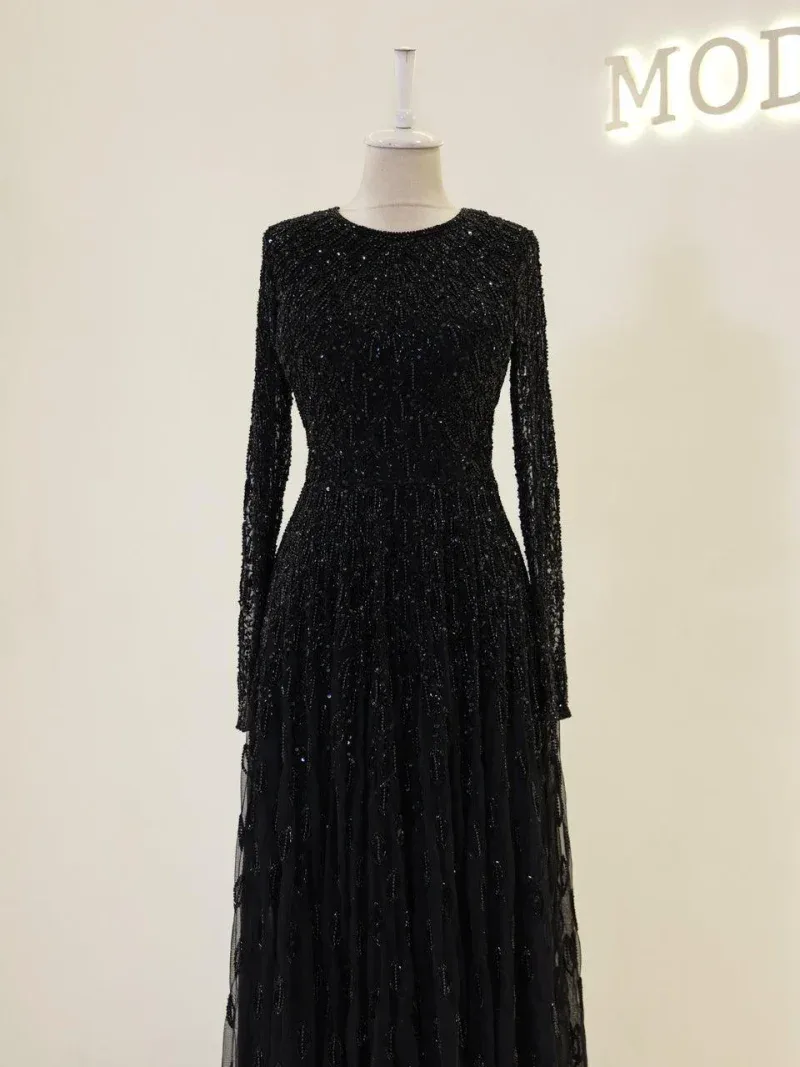 Luxurious black evening dress with intricate beadwork and shimmering details, perfect for formal occasions and special events. Made with high-quality materials for a stunning look.