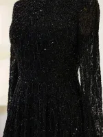 Glamorous black dress adorned with intricate beadwork and sequins, perfect for formal occasions and parties, showcasing detailed craftsmanship and luxurious style.