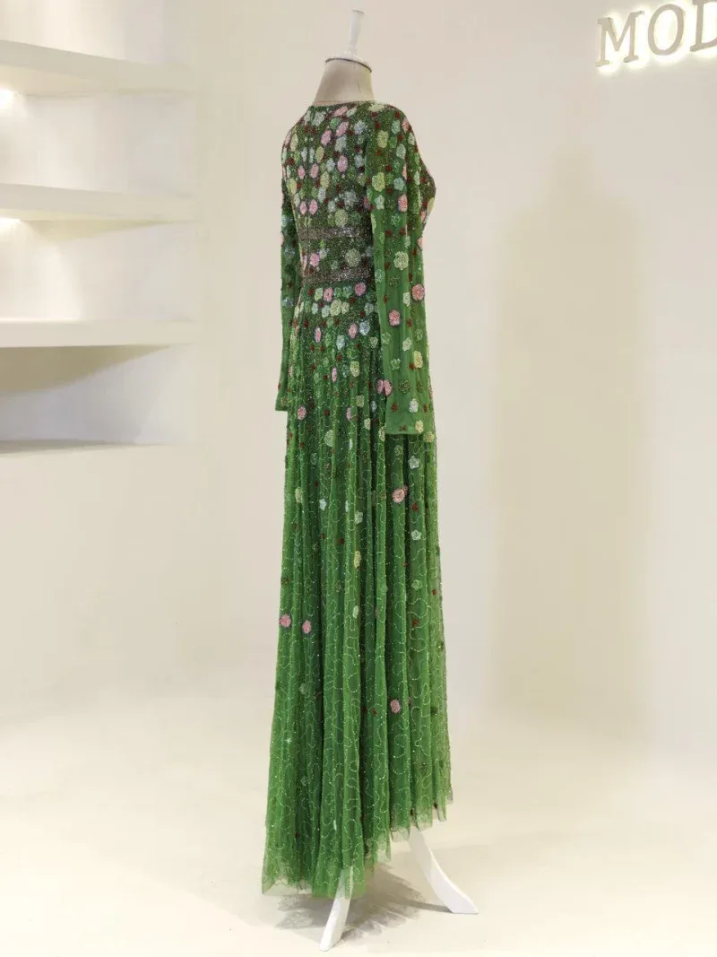 A beautiful green floral dress displayed on a mannequin, emphasizing Turkish fashion craftsmanship with detailed embroidery and elegant flowy fabric, ideal for festive or formal events.