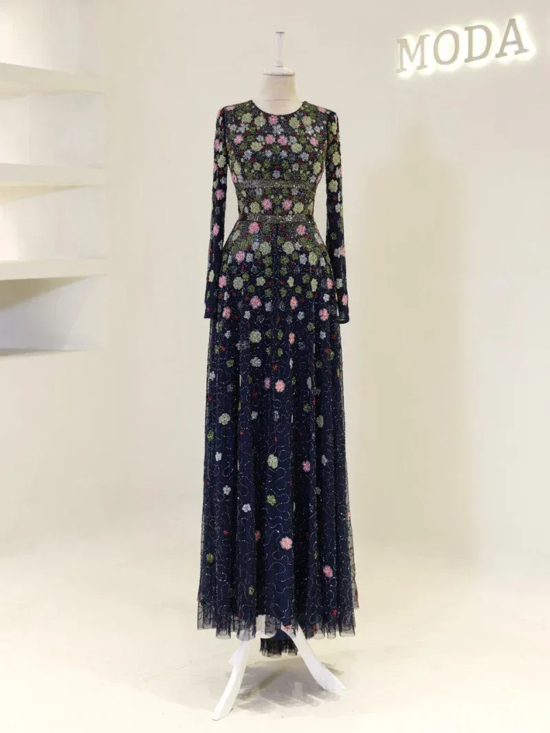 A stunning long dress featuring intricate floral embroidery on tulle fabric, perfect for special occasions or evening events, offering sophistication and style.