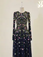 Stylish long-sleeve dress with intricate floral embroidery in pink, green, and white on a dark navy background, perfect for special occasions or upscale events.