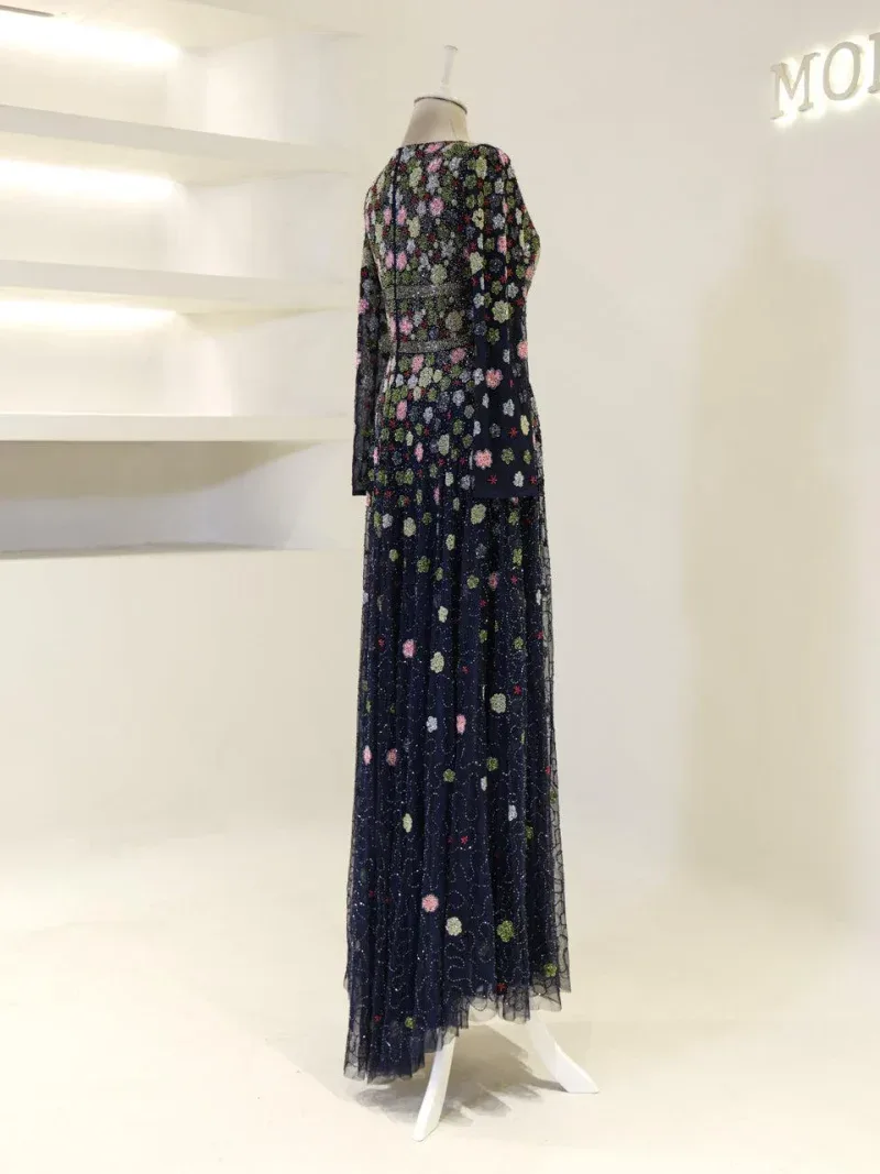 Stunning dark blue dress with colorful floral embroidery, perfect for special occasions or evening events. Features a flowing skirt and intricate detailing, crafted from high-quality fabric for comfort and style.