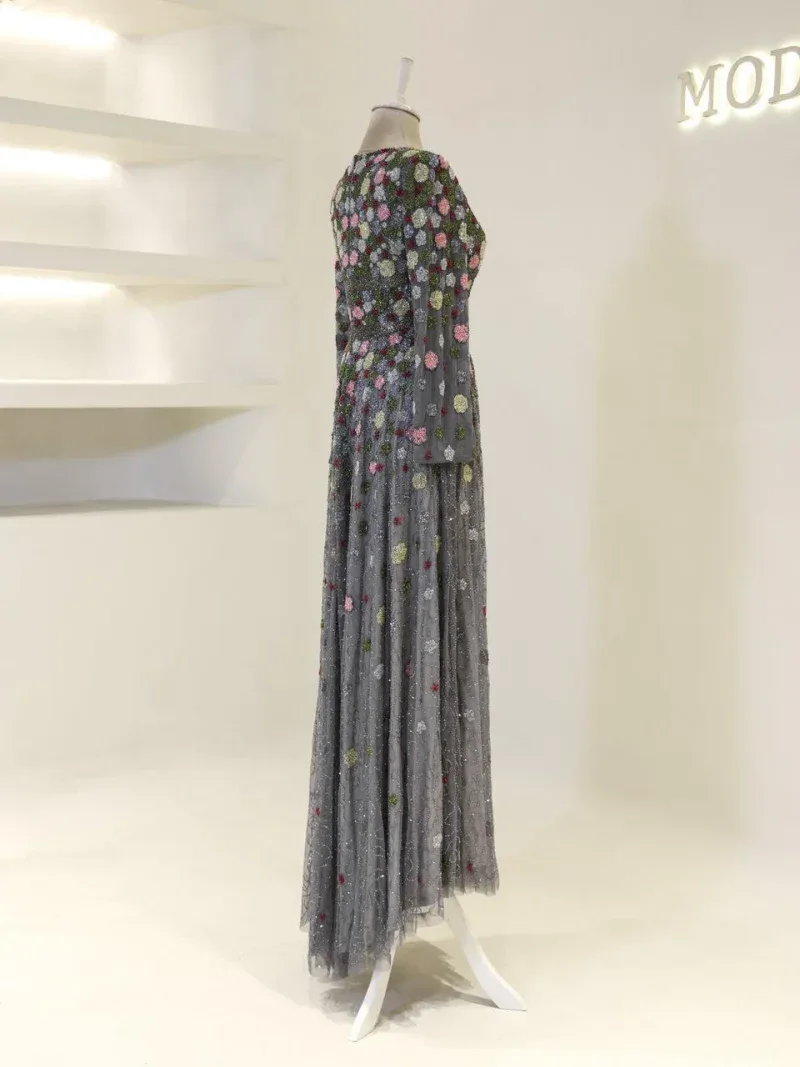 Stylish floral evening dress featuring a layered tulle design adorned with colorful beadwork and embroidery, perfect for formal events and special evenings.