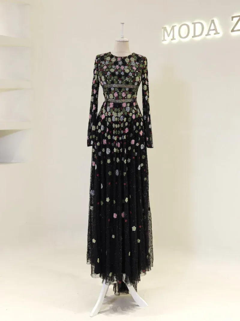 Gorgeous long floral dress with black lace, colorful embroidery, long sleeves, and a flowing skirt, ideal for elegant events and special occasions.