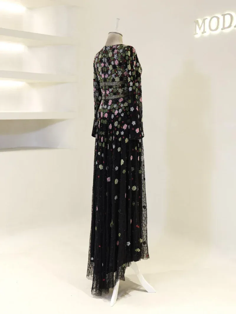 High-quality black dress with colorful floral embroidery and sheer lace fabric, ideal for special occasions, showcasing Turkish fashion craftsmanship.