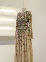 Luxurious long dress with intricate floral embroidery in pink, green, red, and gold on sheer fabric, perfect for special occasions or evening events.