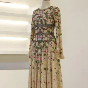 Luxurious long dress with intricate floral embroidery in pink, green, red, and gold on sheer fabric, perfect for special occasions or evening events.