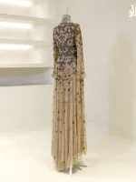 Beautiful floor-length dress with intricate floral embroidery, beige and multicolored blossoms, long sleeves, lightweight fabric, perfect for formal occasions and special events.