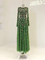 A stunning green floral maxi dress with intricate embroidery, long sleeves, and a flowing skirt, perfect for special occasions and elegant events.