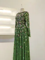 Vibrant green dress featuring intricate floral embroidery, long sleeves, and a flowing skirt, perfect for special occasions and stylish outings.