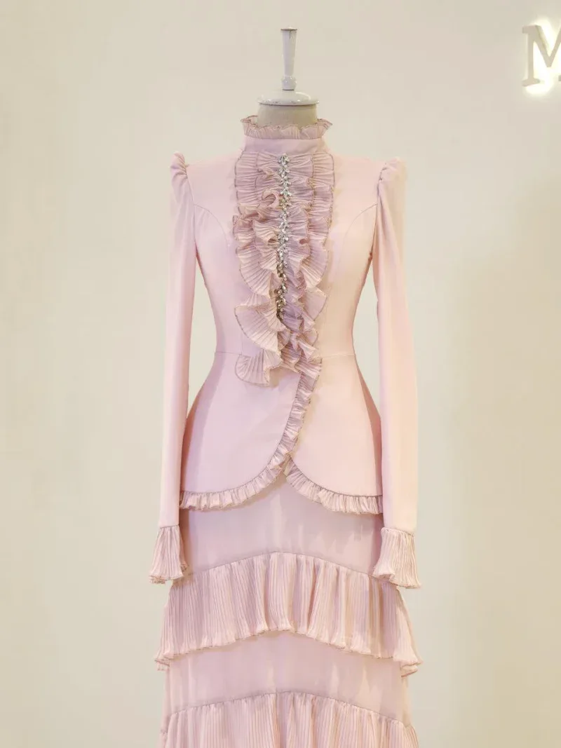 Stylish pink evening dress with ruffles and crystal embellishments, perfect for special occasions and formal events. Made from high-quality fabric, featuring intricate pleats and a sophisticated design.