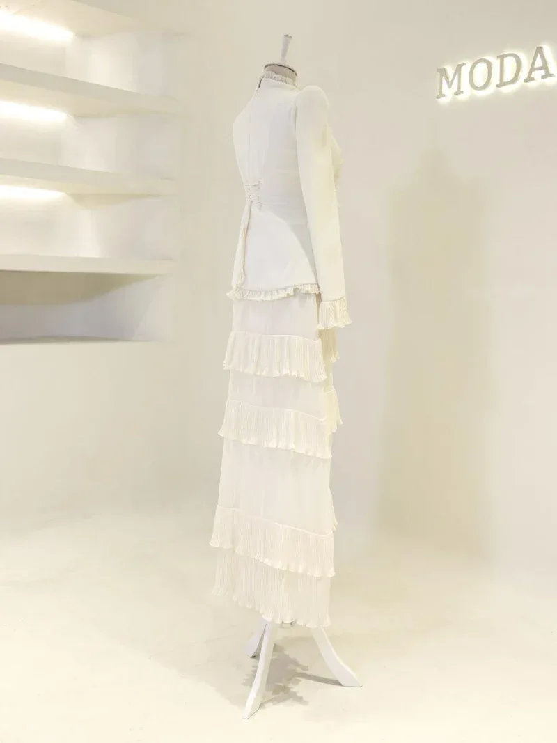 Stylish white tiered dress with ruffled layers, ideal for fashionable events or special occasions, featuring lightweight fabric and a high-quality finish, representing Turkish fashion craftsmanship.