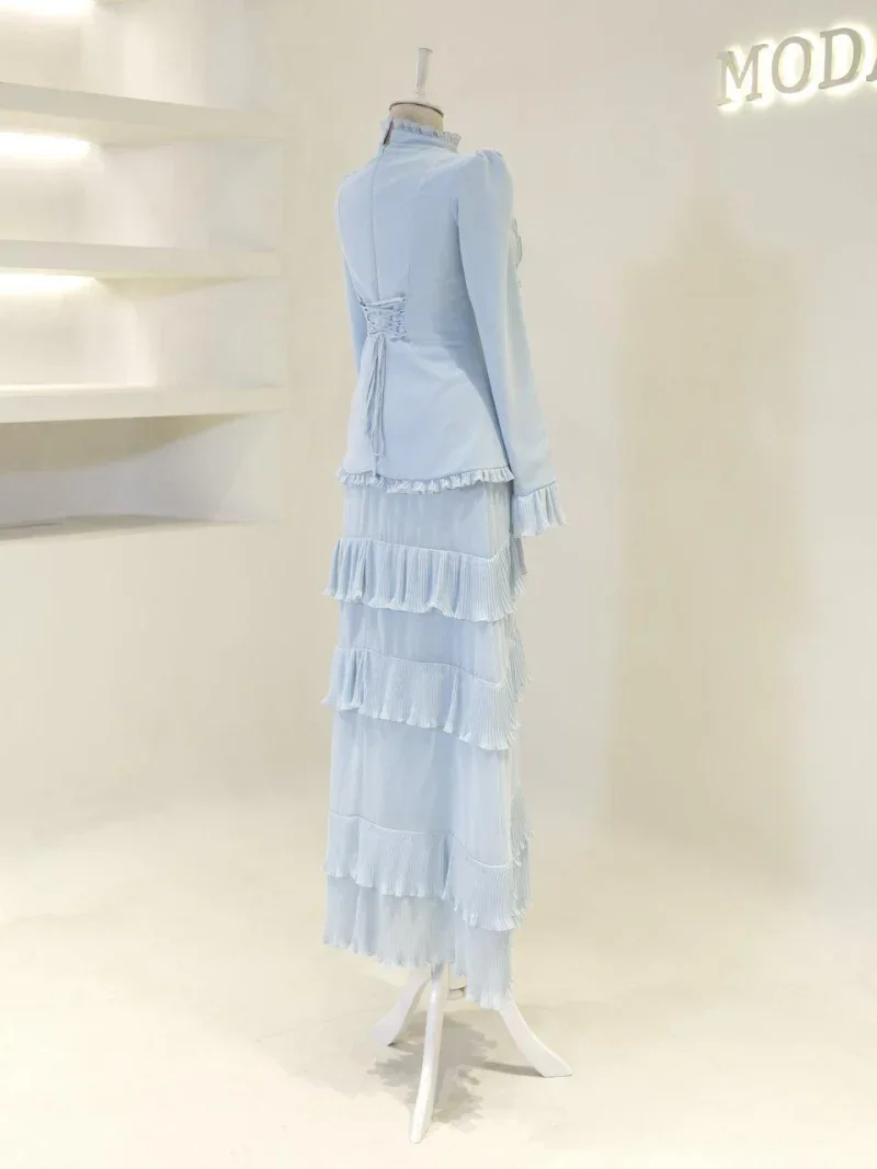 Luxurious light blue dress featuring multiple layered ruffles and pleats, perfect for formal occasions. Crafted from high-quality fabric, it offers a chic and sophisticated look.