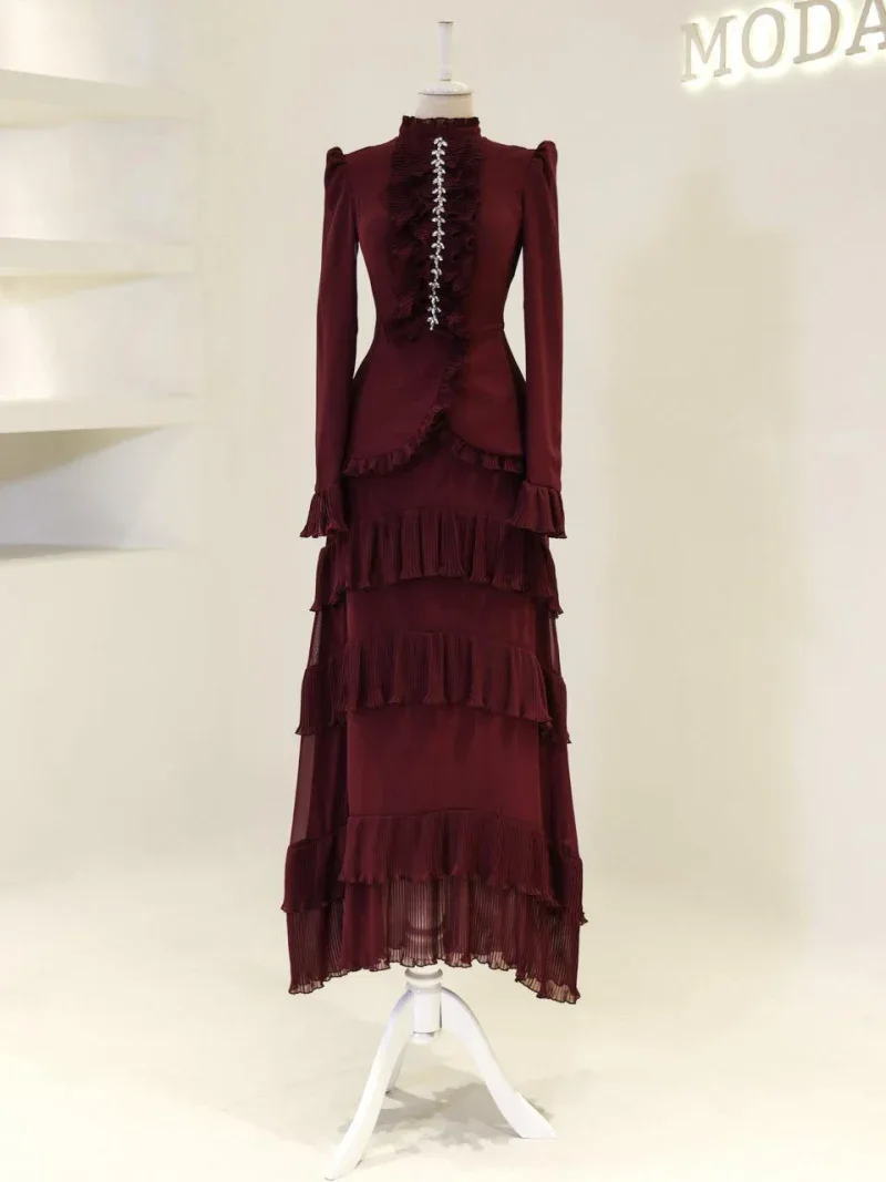 Stylish deep red maxi dress featuring ruffled layers, long sleeves, and intricate detailing, perfect for formal occasions and evening events. Comfortable yet fashionable, available for quick shipping from Turkey.