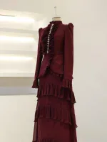 Stunning deep red burgundy dress with layered ruffles and intricate detailing, perfect for formal occasions or fashion events. Made from high-quality fabric for a stylish and comfortable fit.
