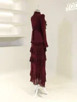 A stylish, deep burgundy dress featuring tiered ruffles and pleats, perfect for sophisticated occasions and evening wear.