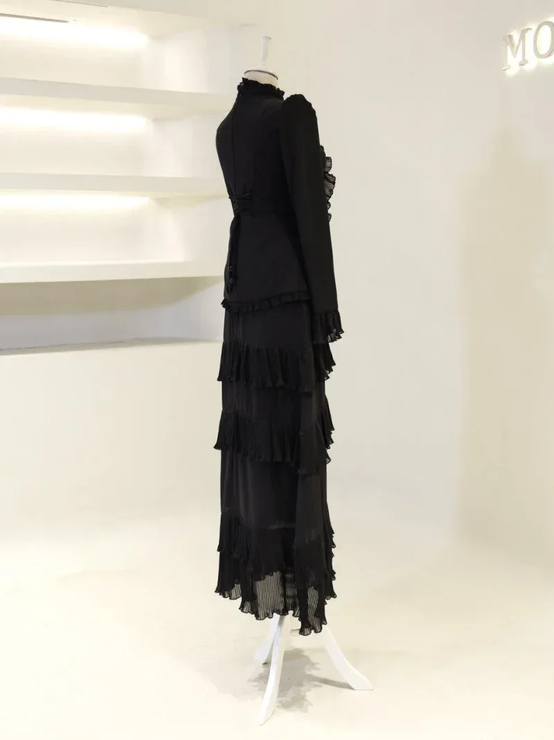 Stylish black dress with layered ruffles and pleats, perfect for formal occasions or fashion-forward events. Made with high-quality fabric for a sophisticated look and comfortable fit.