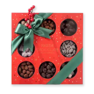 Assorted Turkish chocolates gift box with a green satin ribbon and decorative red berries, perfect for holiday celebrations from Shop of Turkey.