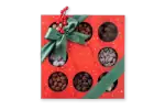 Assorted Turkish chocolates gift box with red ribbon and holiday decorations, perfect for gift-giving during festive seasons.