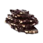 Rich dark chocolate with cranberries and chopped nuts, stacked on black background for premium Turkish chocolate treats.