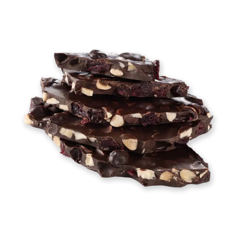 Rich dark chocolate with cranberries and chopped nuts, stacked on black background for premium Turkish chocolate treats.