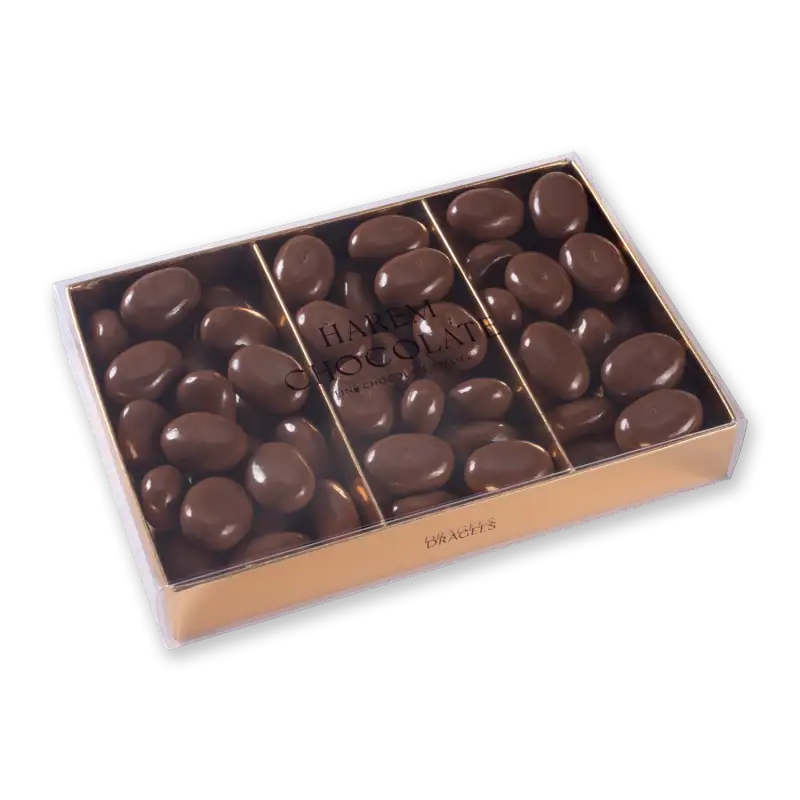 Delicious Turkish milk chocolates in a clear box with gold accents, perfect for gifting or indulgence. Shop of Turkey offers fast shipping on premium Turkish chocolates.