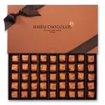 Luxurious box of assorted Harem Chocolate wrapped in elegant orange foil, perfect for gifting or indulgence from Turkey's finest artisan chocolate shop.