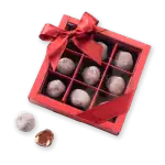 Rich Turkish chocolate truffles in a decorative gift box with a red ribbon and bow, perfect for special occasions.