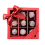Delicious powdered Turkish delight chocolates in a decorative gift box with a red ribbon. Perfect for gifting or savoring authentic Turkish treats.