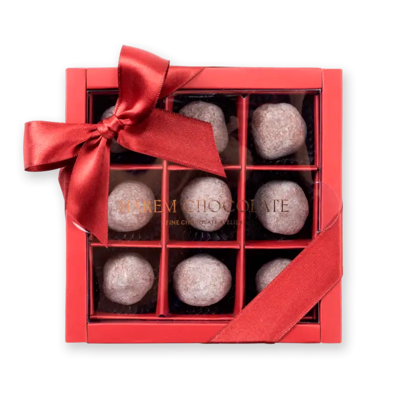 Delicious powdered Turkish delight chocolates in a decorative gift box with a red ribbon. Perfect for gifting or savoring authentic Turkish treats.