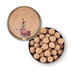 Delicious Turkish caramel candies in a round tin with artistic label featuring a woman and celestial design. Perfect for gifting or enjoying Turkish sweets at home.