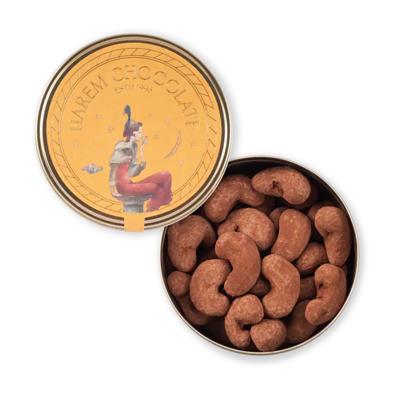 Golden chocolate coin tin featuring a whimsical illustration of a woman blowing a bubble, filled with roasted cashews, perfect for sweet gifts and snacks.