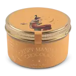 Elevated image of crispy mandarin chocolate tin with artistic illustration of a woman reading, featuring warm tones and elegant design. Perfect for gift or personal indulgence.