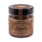 Rich chocolate hazelnut spread jar with black lid, made with Ghanaian hazelnuts, free from sugar, ideal for desserts, snacks, and gift-giving from Turkey.