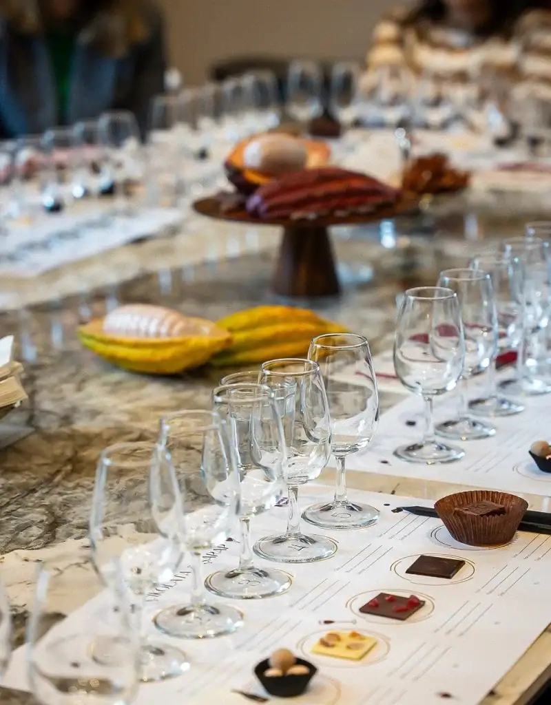 1. Elegant Turkish dining setup with empty wine glasses, chocolates, and a cheese platter on a marble table, perfect for luxurious food shopping from Turkey.