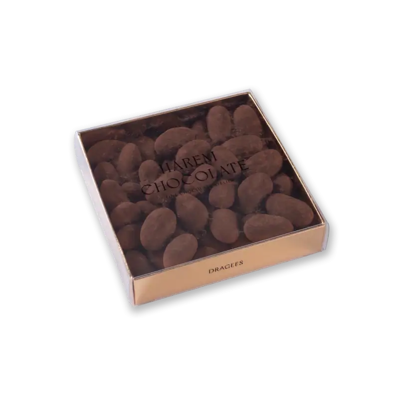 Rich, dark Turkish chocolate almonds in a clear box with elegant gold accents, perfect for gifting or indulging. Fast shipping from Turkey.
