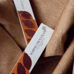 Rich dark chocolate bar from Hareem Chocolate on textured brown fabric, perfect for gifting or indulgence.