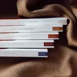 Rich, dark chocolate cacao pod chocolates with various flavors including caramel, bitter, and sugar-free options, beautifully packaged on a textured brown fabric background.