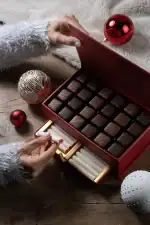 1. Luxurious box of assorted Turkish chocolates with festive holiday decorations on a wooden table.