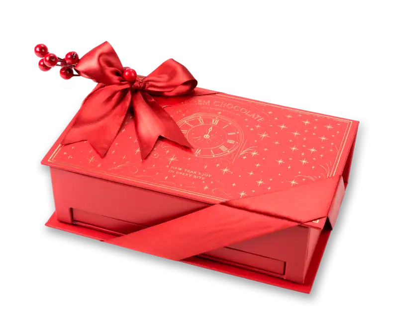 Vibrant red holiday chocolate gift box with gold accents, ribbon, and festive bow for Christmas or New Year's celebrations.