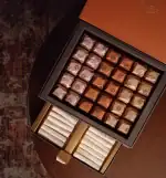 Luxurious box of assorted original Turkish chocolates with metallic wrapping, including wrapped candies and wafer rolls, perfect for gifting or indulging in Turkish sweets.