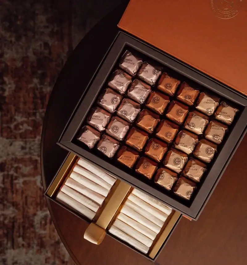 Luxurious box of assorted original Turkish chocolates with metallic wrapping, including wrapped candies and wafer rolls, perfect for gifting or indulging in Turkish sweets.