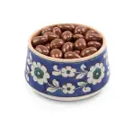 Creamy chocolate-covered almonds in a traditional Turkish ceramic bowl with floral patterns, perfect for gifting or enjoying as a sweet treat from Turkey.