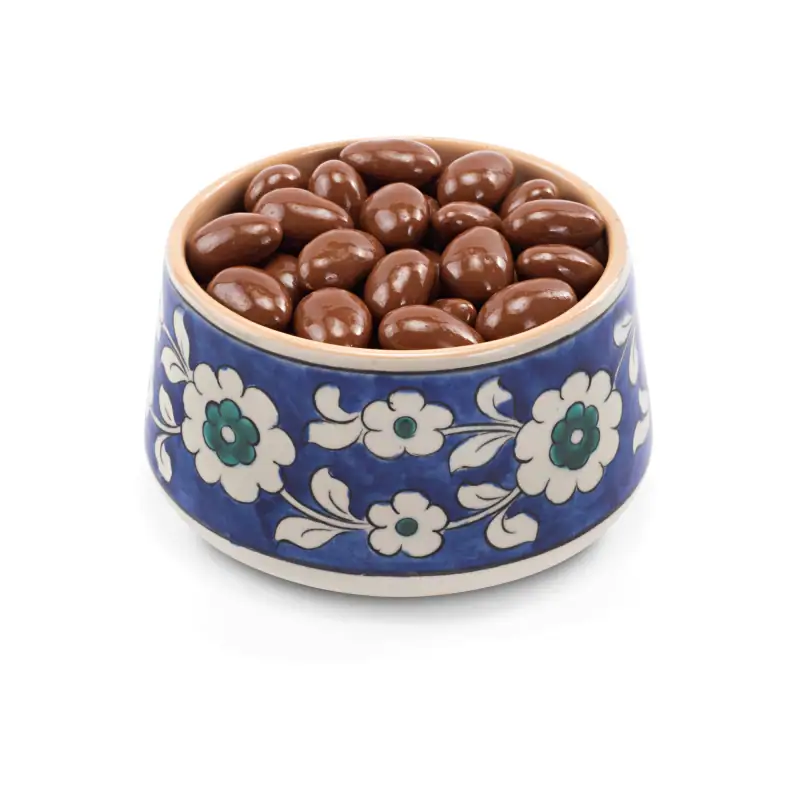 Creamy chocolate-covered almonds in a traditional Turkish ceramic bowl with floral patterns, perfect for gifting or enjoying as a sweet treat from Turkey.