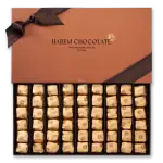 Cream-colored wrapped chocolates in a black box with a brown lid and ribbon, representing Turkish luxury chocolates.